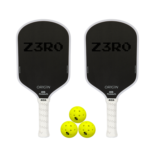Two pickleball paddles with 'Z3RO' branding and three yellow pickleballs